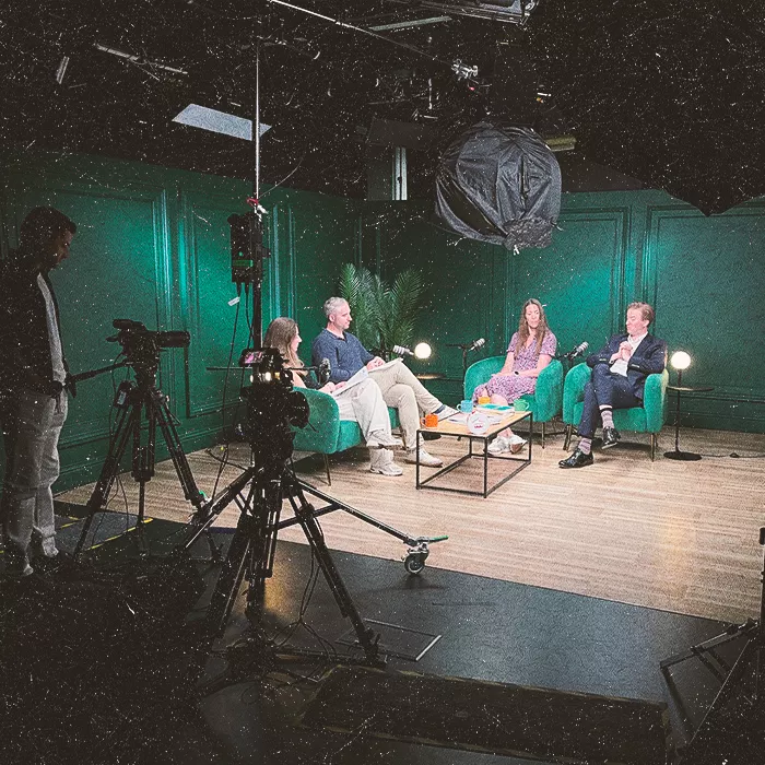 Four people in green chairs discussing