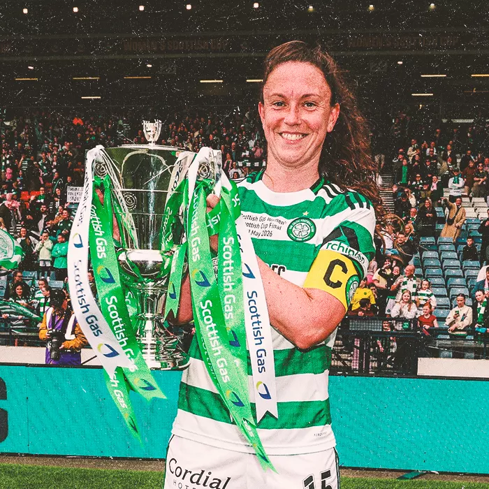 Woman in sports attire holding a trophy with both hands
