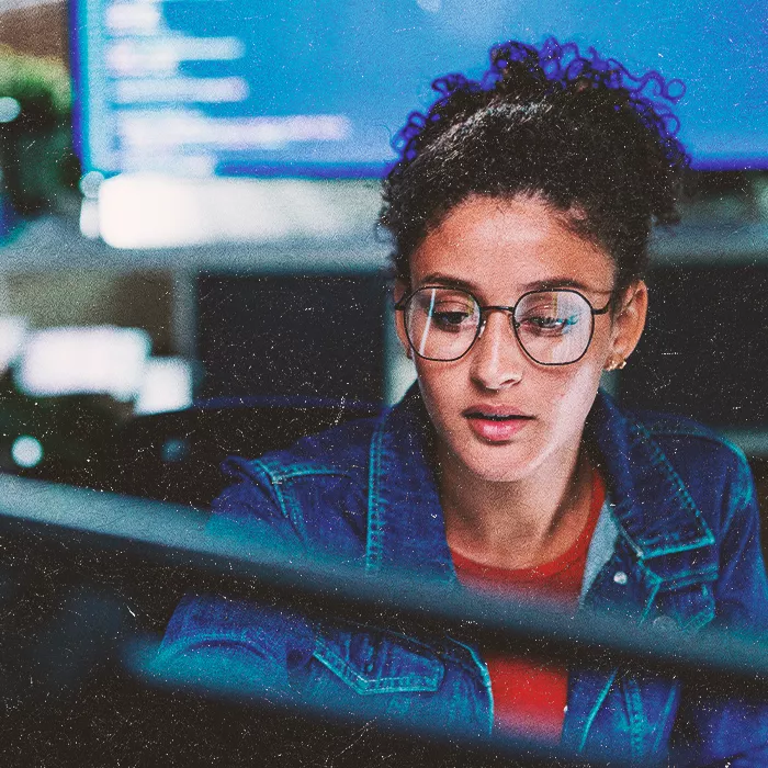 Woman with glasses working at a screen