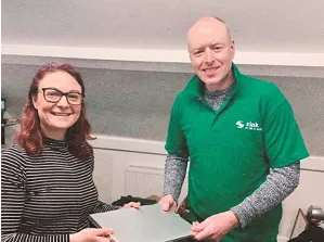 Two smiling people holding laptop looking towards the camera