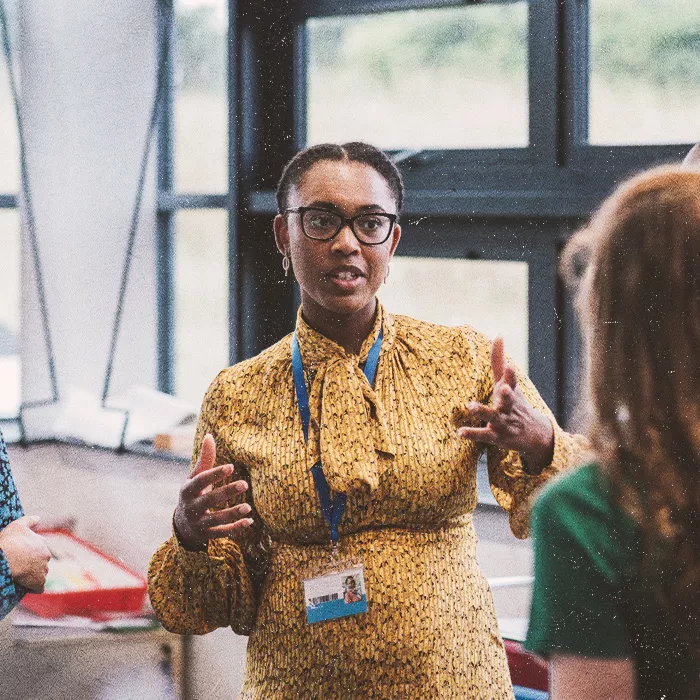 Woman in a yellow dress in mid-conversation