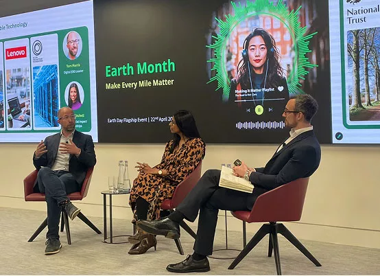 Three people in panel discussion with a screen in the background