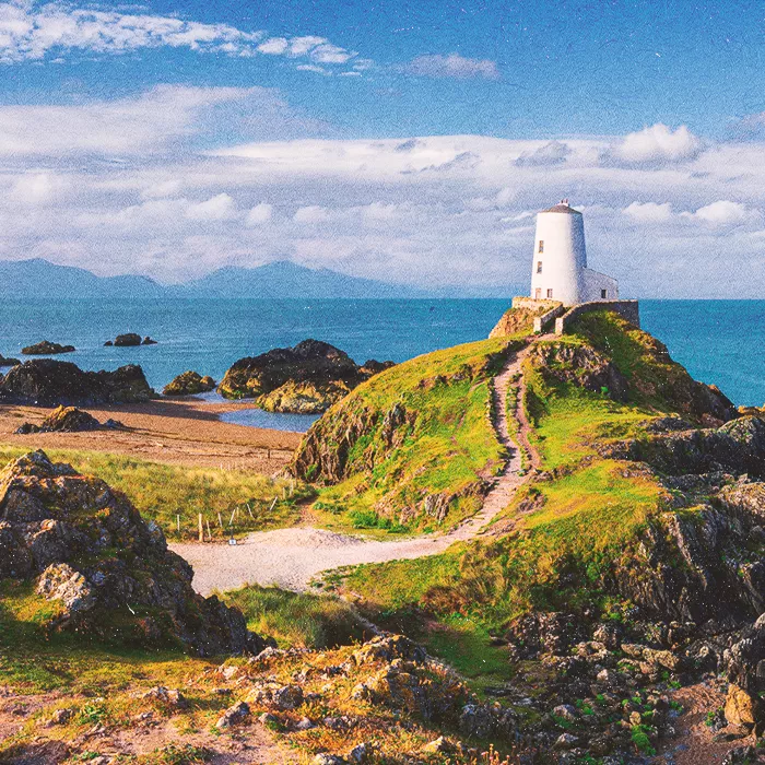 Lighthouse at the top of a hill in sunlight