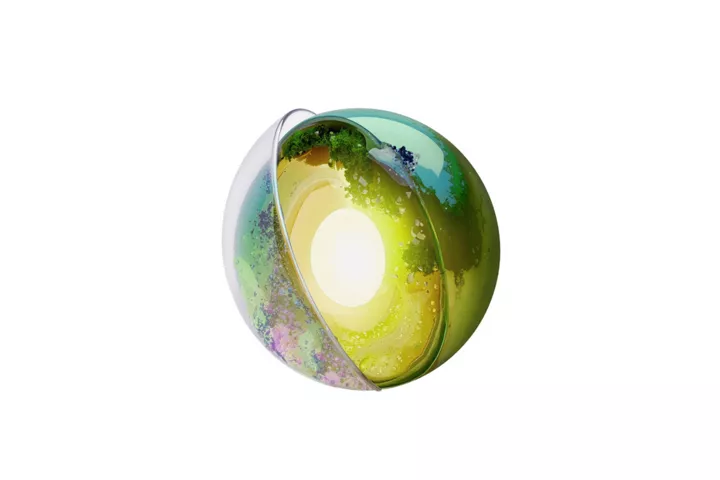 Abstract glowing green orb with sliced shell and bright white core on black background