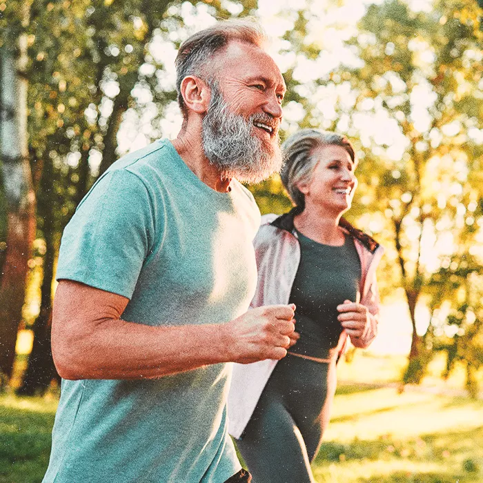 A man and a woman jogging next to each other outside