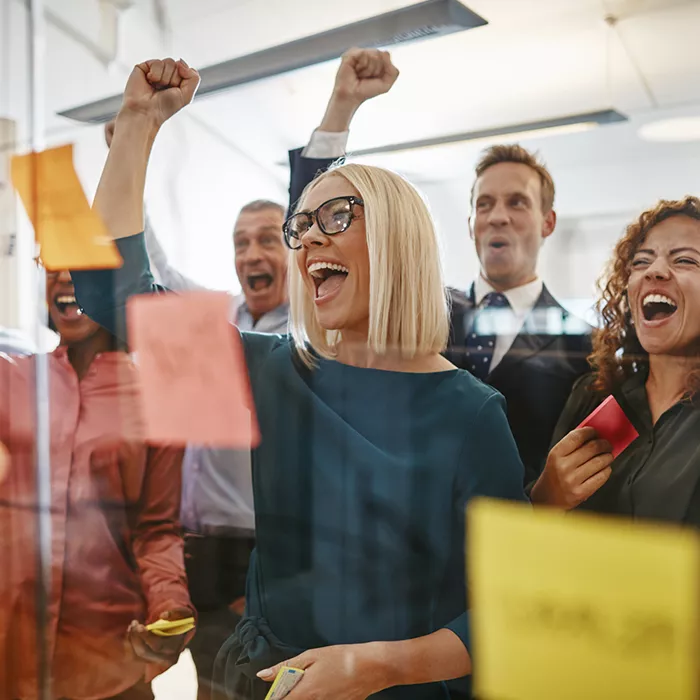 Five people cheering in an office
