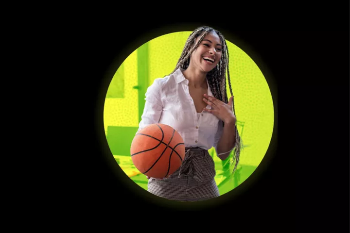 Smiling woman holding a basketball inside a circular frame on a black background.