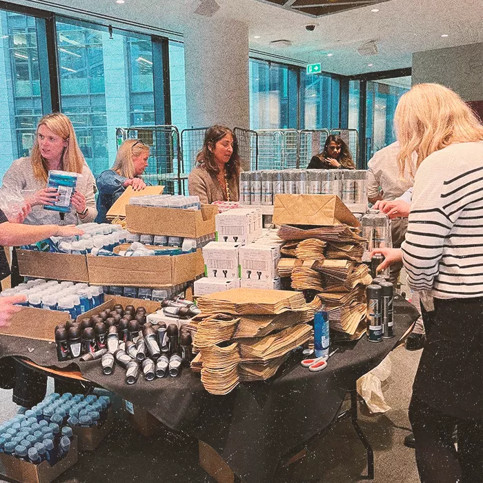 Women standing around a table with supplies