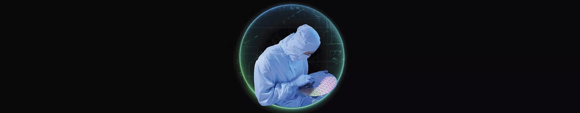 A person dressed in a clean suit examines a microchip wafer