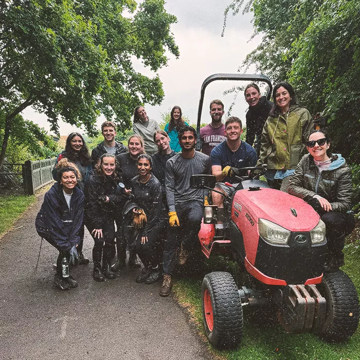 Happy people standing around a tractor